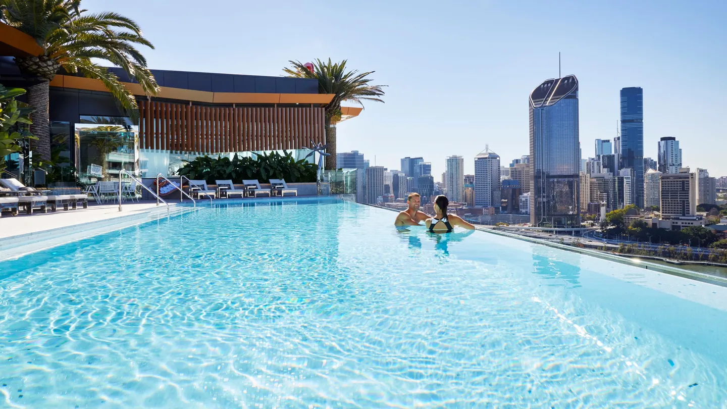 325982-image-of-young-couple-in-the-rooftop-terrace-infinity-pool-at-the-emporium-hotel-southbank-overlooking-brisbane-city_southbank_brisbane-city