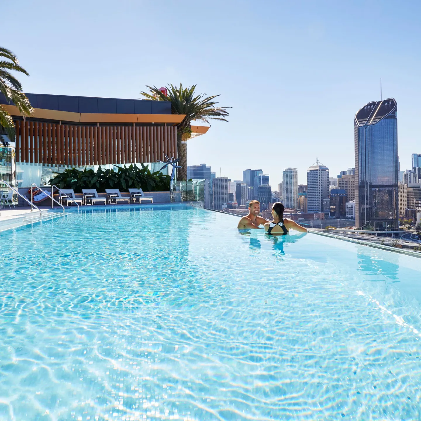 325982-image-of-young-couple-in-the-rooftop-terrace-infinity-pool-at-the-emporium-hotel-southbank-overlooking-brisbane-city_southbank_brisbane-city